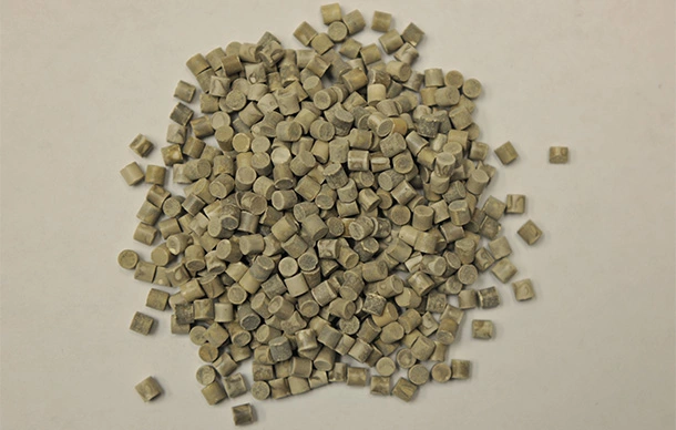 Pile of palladium catalyst cylinders on a table.