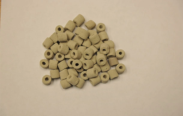 Pile of silver rings on a table in a refining shop.