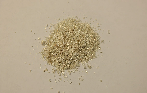 Cluster of raw silver needles on a table in a refining shop.